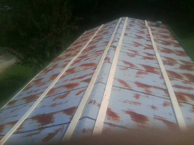 Rusted metal roof panels with new wood purlins before replacement — Storm Damage Roof Repair in Willow Wood by Roofing Brothers
